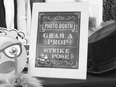 a sign welcomes guests to the photo booth