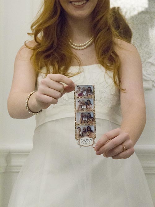 A woman holding up her photos.