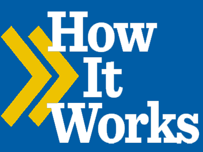 A guest writes on a scrapbook page.